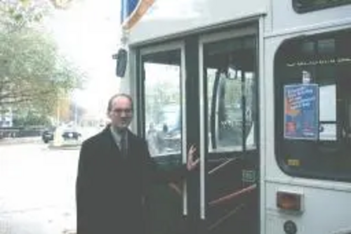 Michael Headley alongside a bus