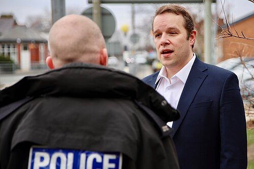 Tom Morrison MP talking to a police officer