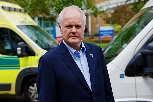 Wokingham's MP, Clive Jones, stood in front of ambulances at Royal Berkshire Hospital