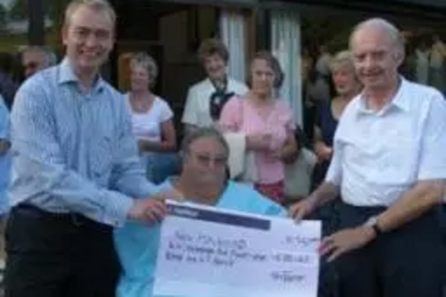 Tim presenting a cheque to the New Holehird charity