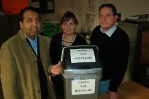 Zuffar Haq, Cllr Debbie Almey and Jeff Stephenson recycle paper at New Walk Centre.