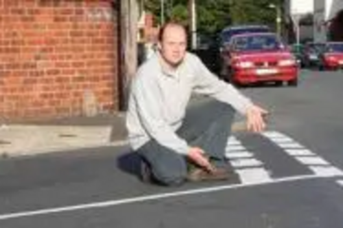 Robin Lawrence inspects the freshly painted road markings