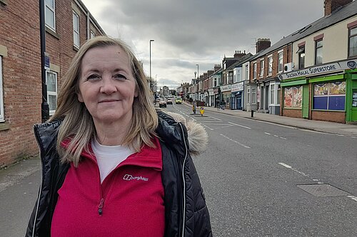 Councillor Julia Potts standing at the bottom of Chester Road in Sunderland with shops behind her