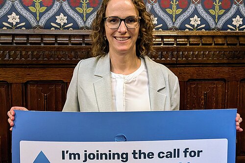 Alison Bennett holding water campaign banner