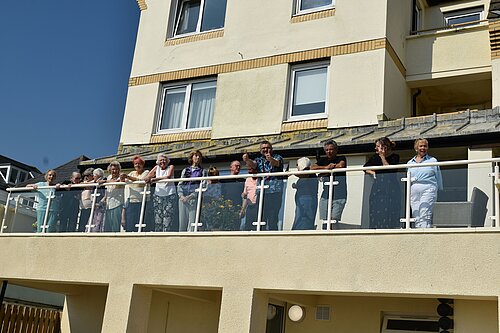 Tim Prater with Homevale House owners, tenants and residents on the newly completed balcony.