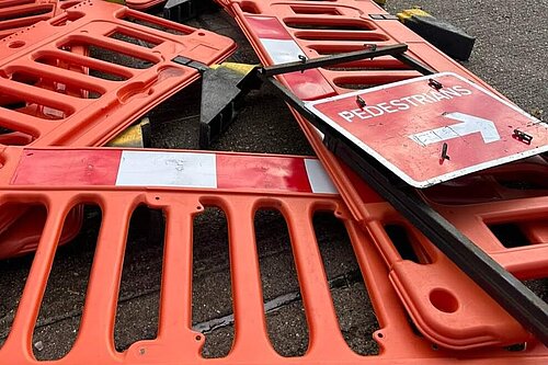 Fallen plastic barriers and Pedestrian sign