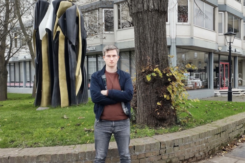 Anthony in front of the Don Statue looking unhappy