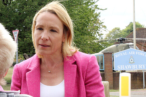 Helen Morgan outside RAF Shawbury with Helicopter