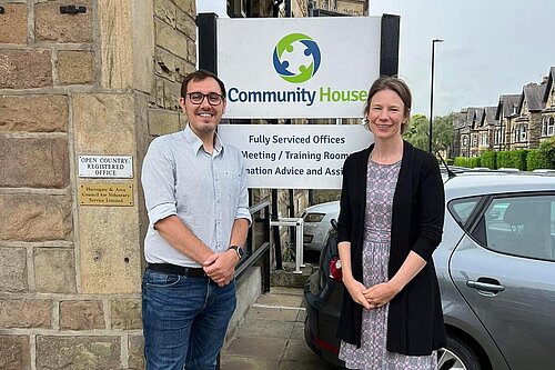 Tom Gordon and the CEO of HADCA in front of Harrogate Community House sign