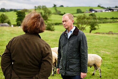 Tim listening to a farmer