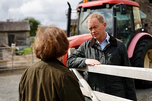 Tim listening to a local farmer