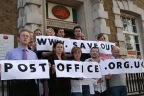 Shepway Lib Dems outside Folkestone Post Office with www.saveourpostoffice.org.uk banner