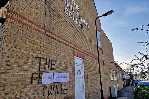 Graffiti spray-painted onto the wall of the Islamic Sharia Counil building in Leyton