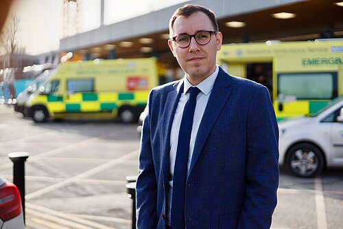 Tom Gordon stood outside Harrogate District Hospital with ambulances in the background